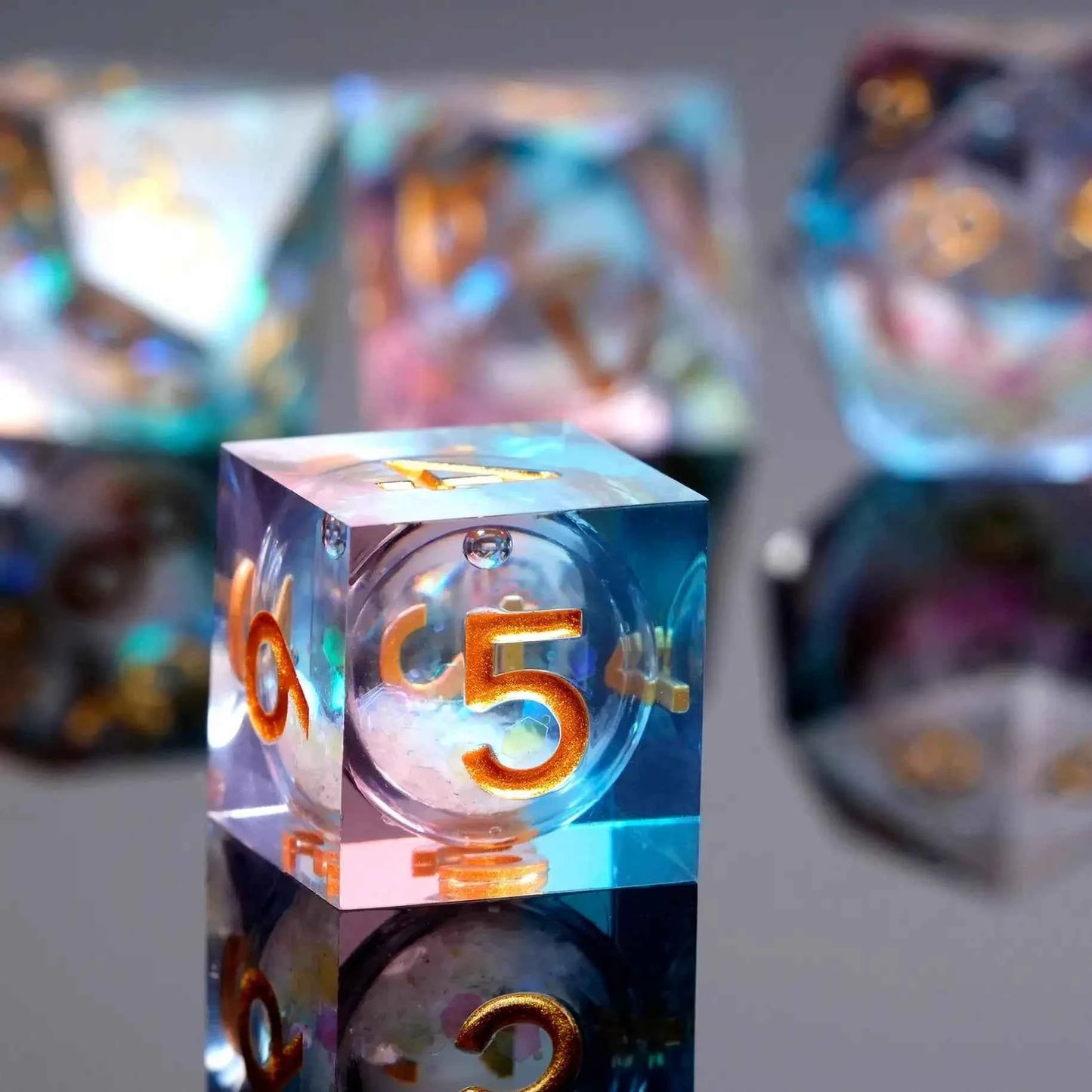 Transparent powder blue resin sequin liquid core dice set with gold numbers
