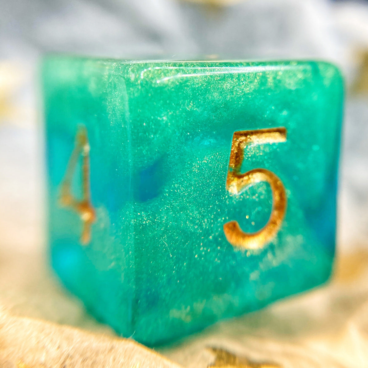 Tusktooth Fjord Inspired D6 – Handmade Glow-in-the-Dark Green & Blue Gaming Die with Gold Grinning Face