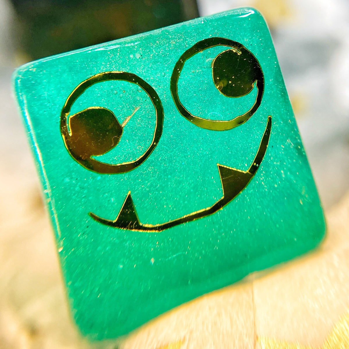 Tusktooth Fjord Inspired D6 – Handmade Glow-in-the-Dark Green & Blue Gaming Die with Gold Grinning Face