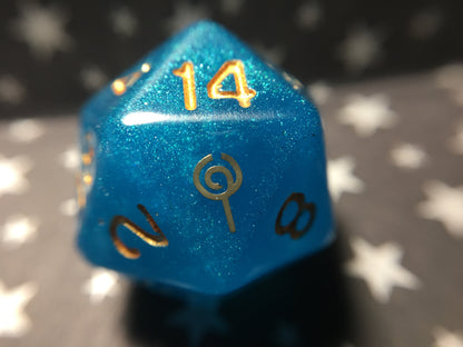 Jester Inspired D20 – Handmade Shimmering Blue Gaming Die with Metallic Gold Numbers & Lollipop Symbol